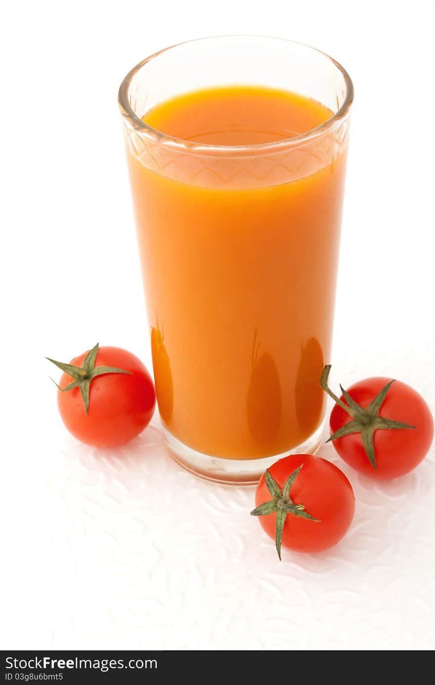 Glass of vegetable juice and fresh tomatoes on white background. Glass of vegetable juice and fresh tomatoes on white background