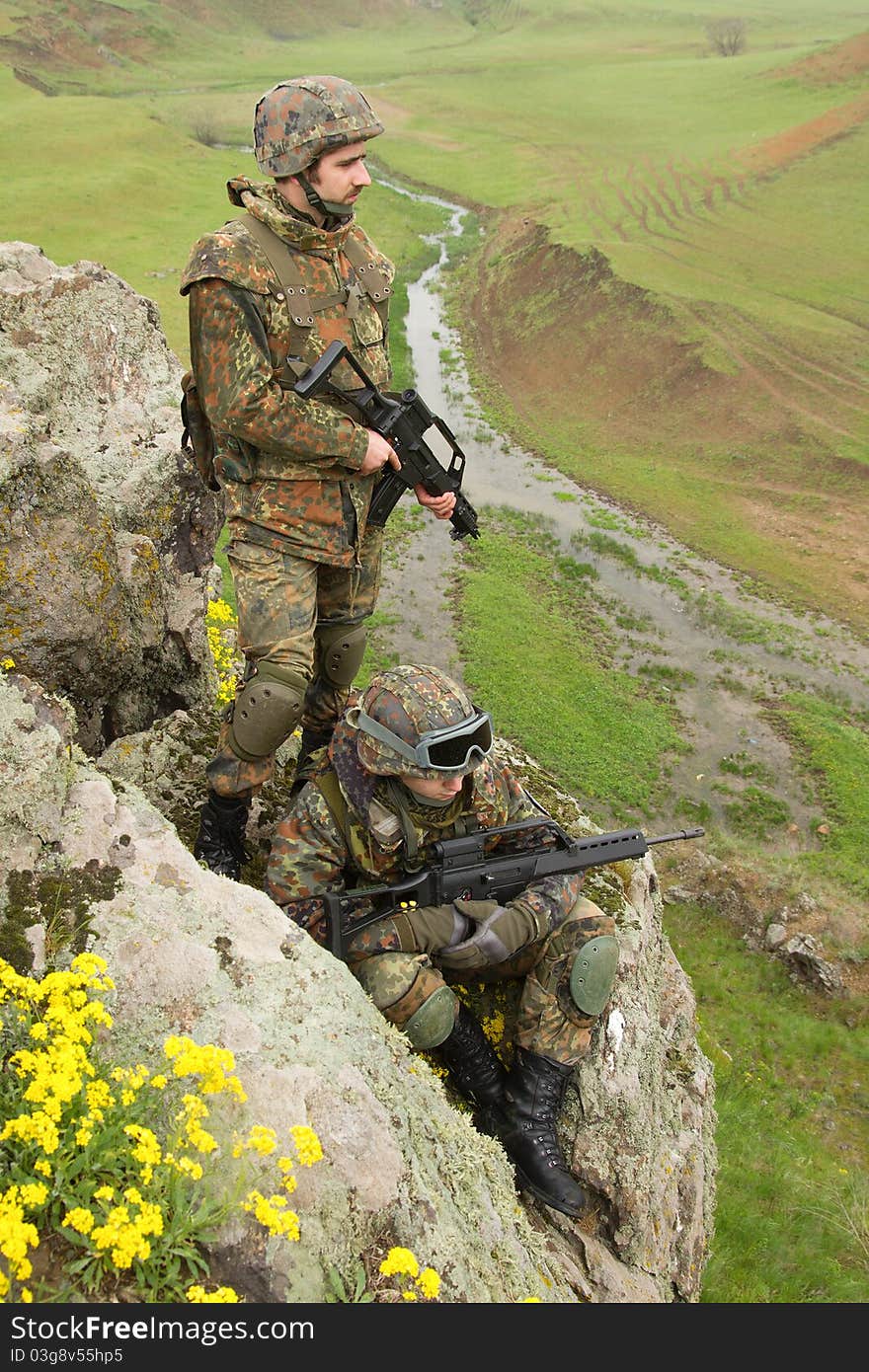 Soldiers in heavy ammunition on the rock