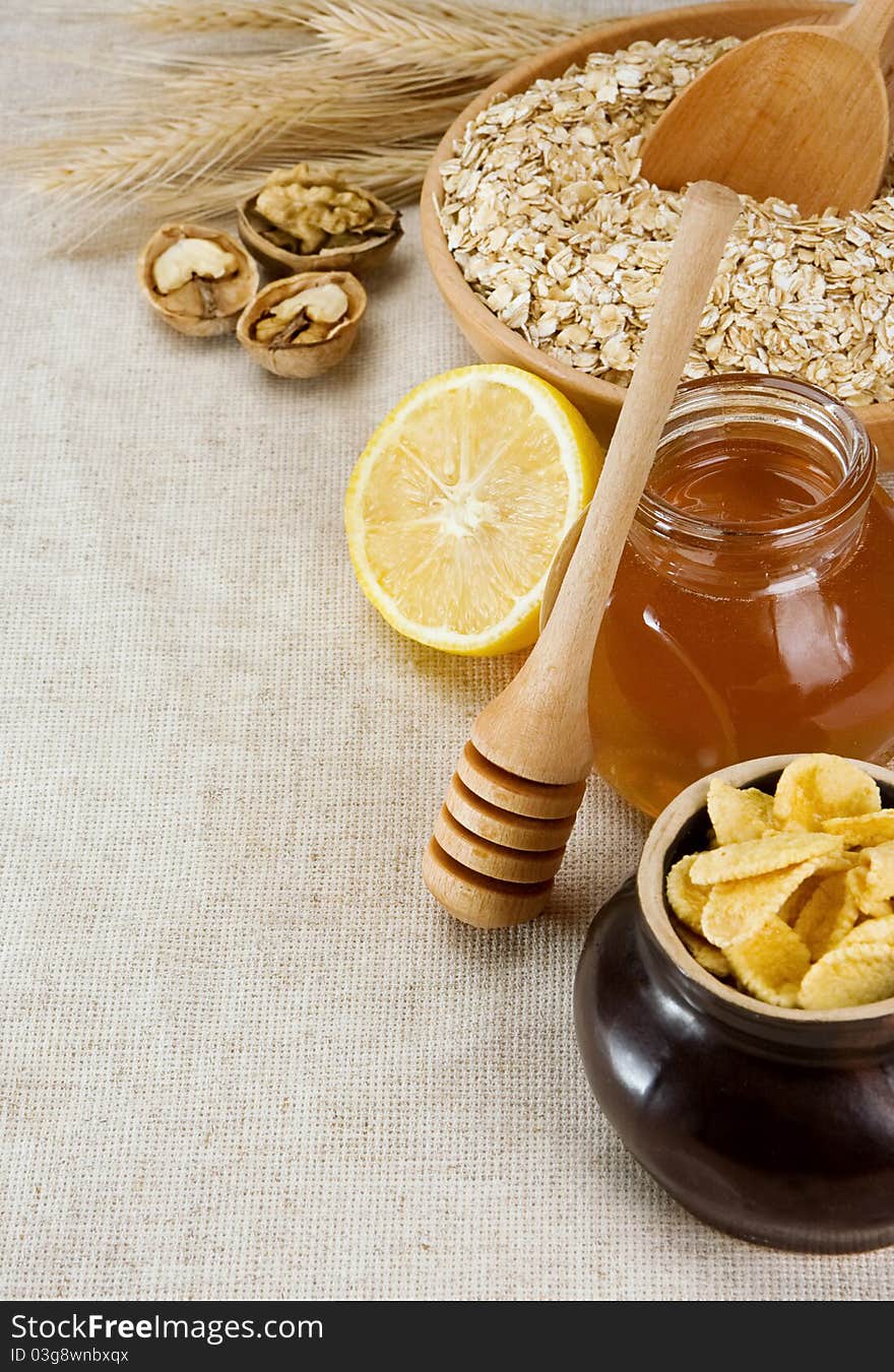 Plate of oat, honey and healthy food on sack