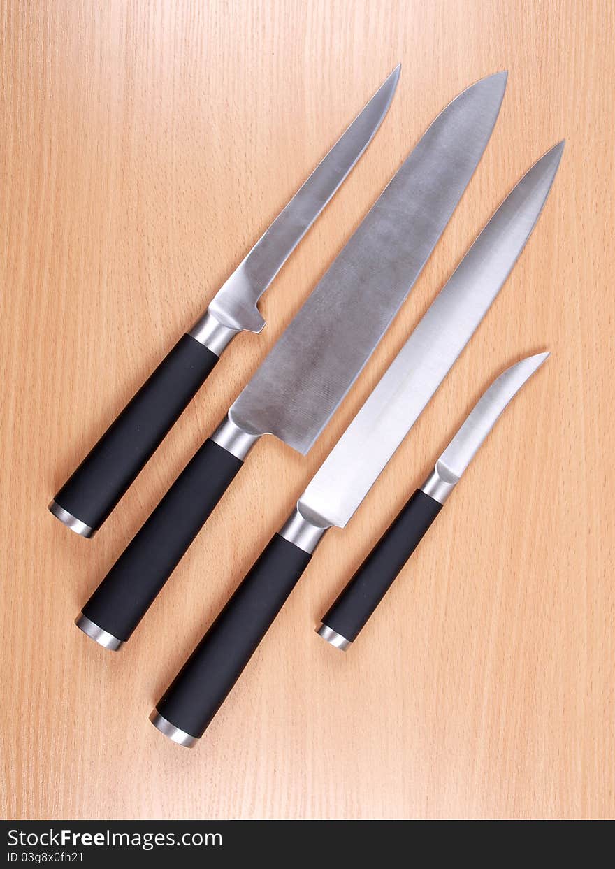 Set kitchen knives on wood