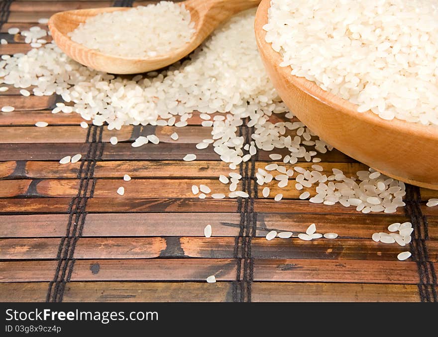 Rice and wood plate with spoon on table