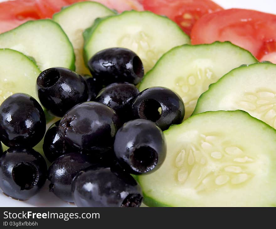 Color photograph of sliced tomatoes and cucumbers on a plate. Color photograph of sliced tomatoes and cucumbers on a plate