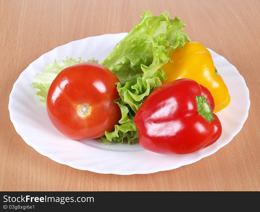 Color photograph of tomatoes and peppers on a plate