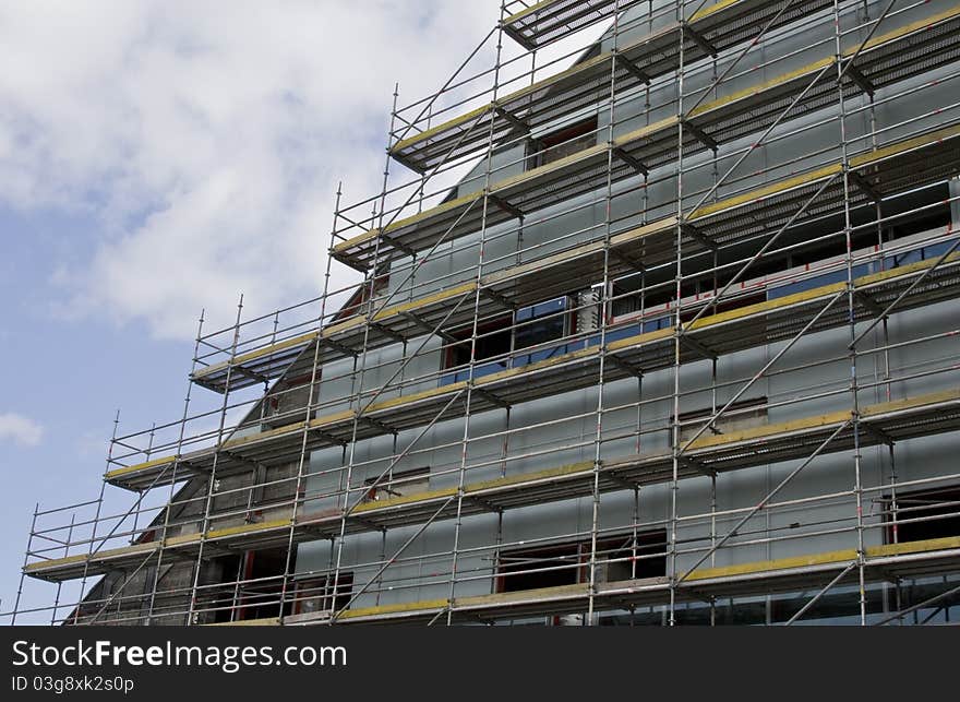 Construction of new building with clouds on background