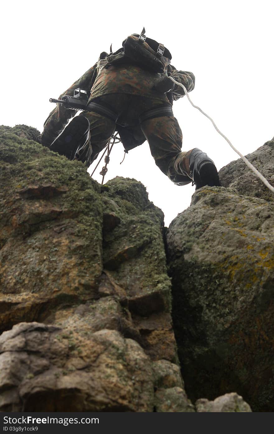 Military man does dangerous rappeling in combative ammunition. Military man does dangerous rappeling in combative ammunition