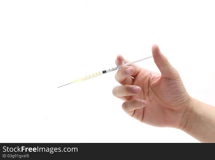 Hand hold disposable syringe isolated on the white background. Hand hold disposable syringe isolated on the white background