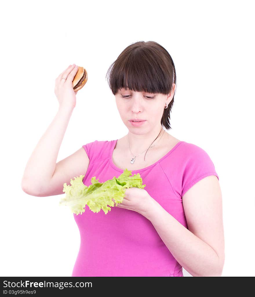 The young woman throws out a hamburger holding salad