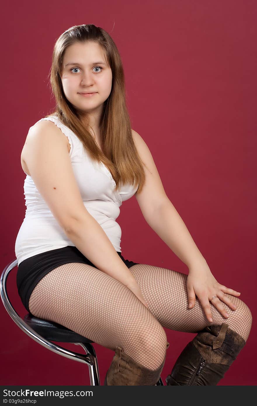 Woman in shorts and t-shirt  sitting on chair