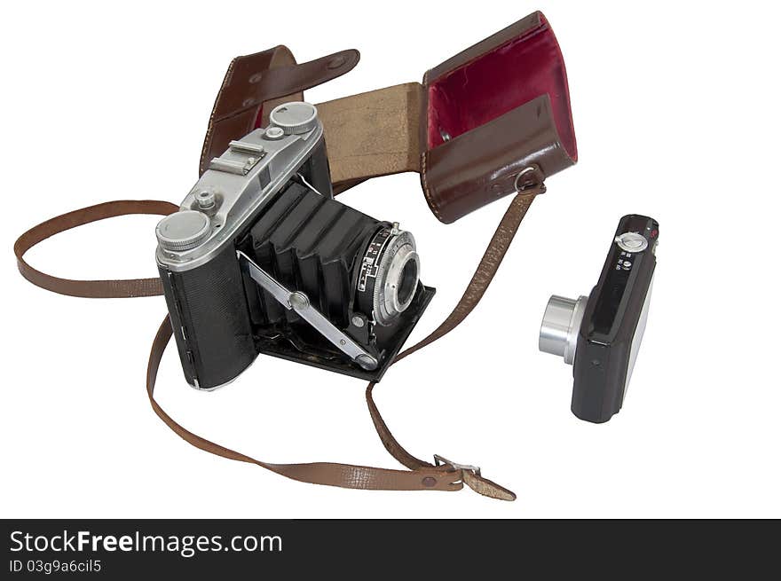 An old analogic camera beside a new digital compat camera isolated with a white backround. An old analogic camera beside a new digital compat camera isolated with a white backround