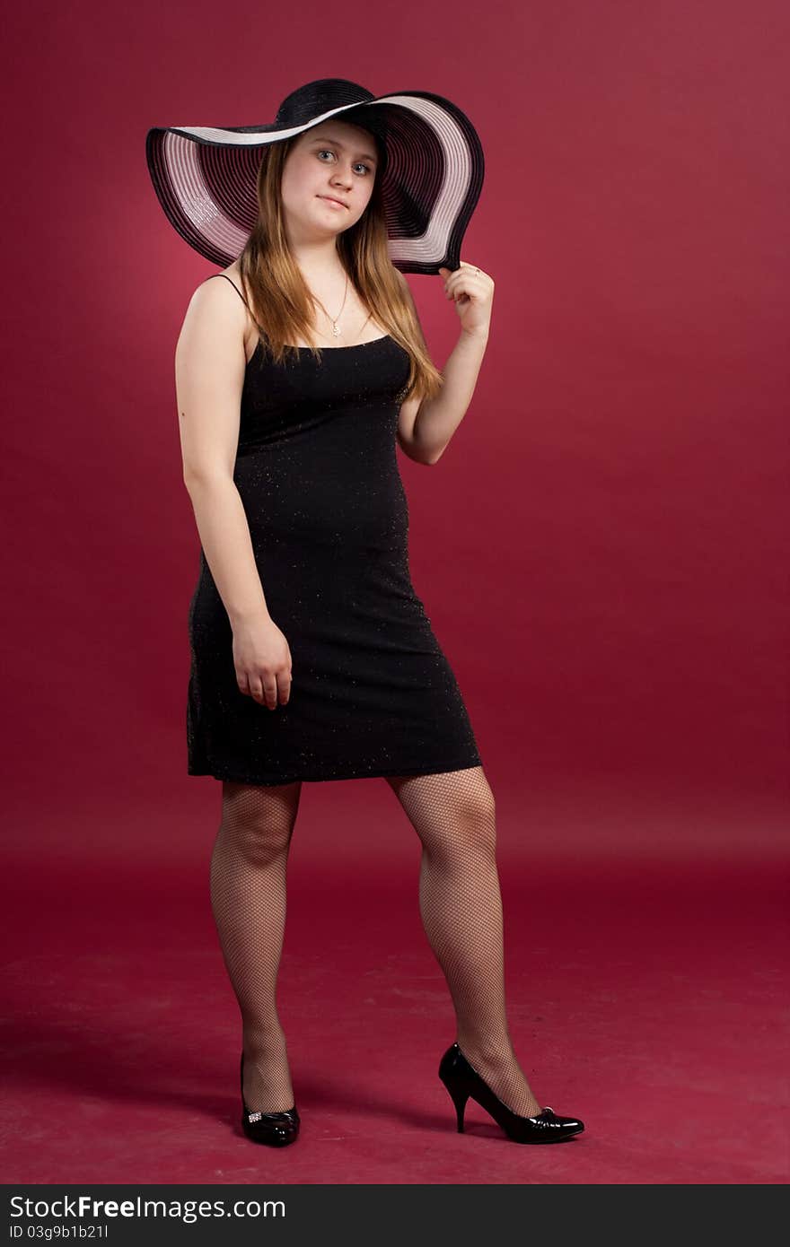 Girl standing in studio isolated on red background. Girl standing in studio isolated on red background