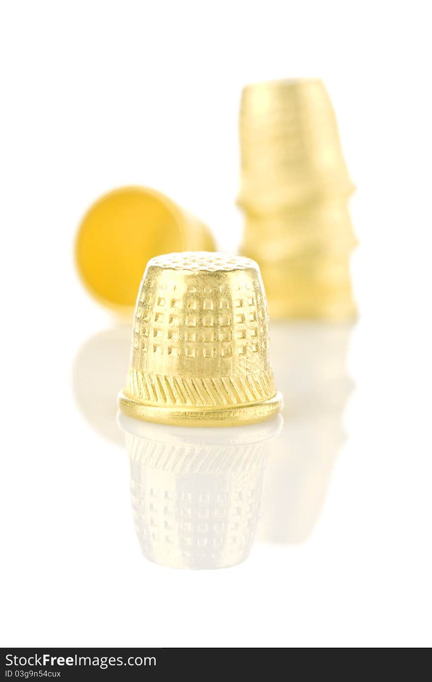 Composition of golden Thimbles isolated on white background