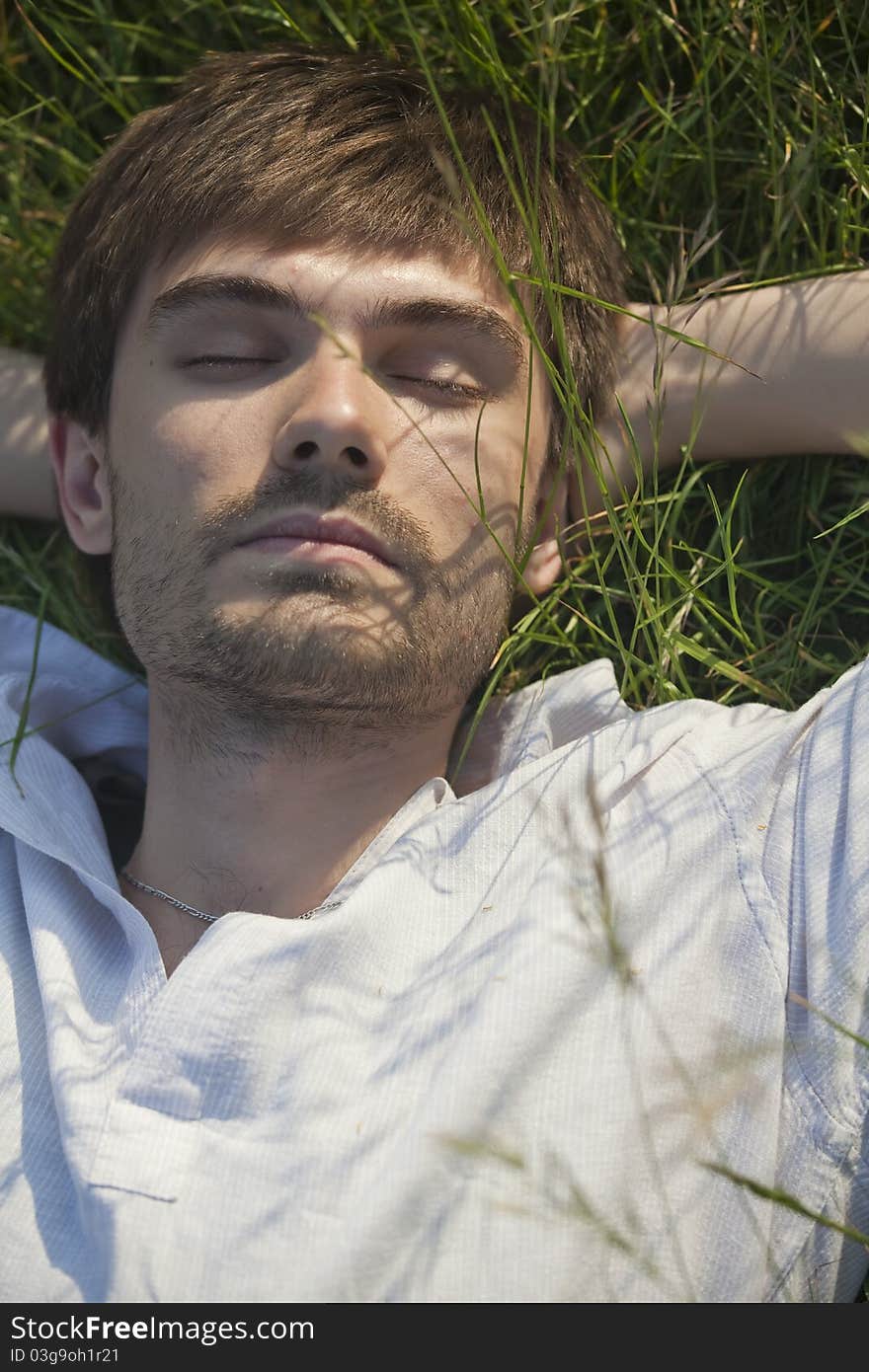 Man relaxing and sleeping in field. Man relaxing and sleeping in field