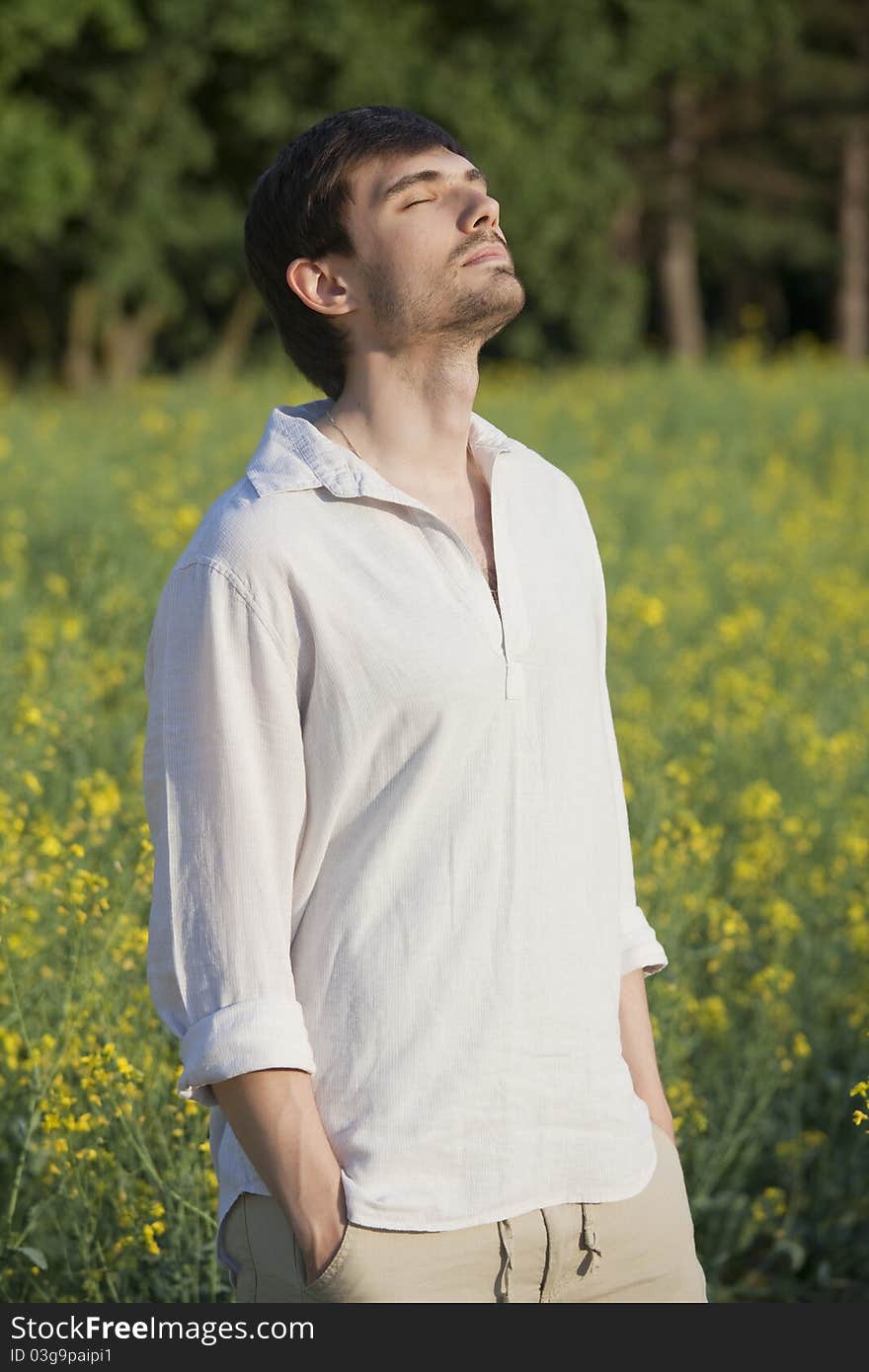 Man in field enjoying sunset