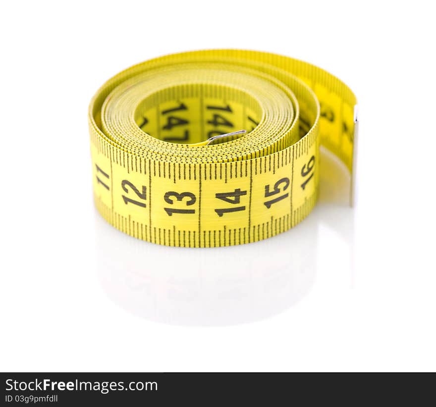 Studio shot roll of yellow tapeline isolated on white background