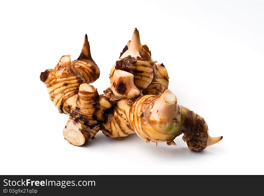 Galangal root isolated against a white background