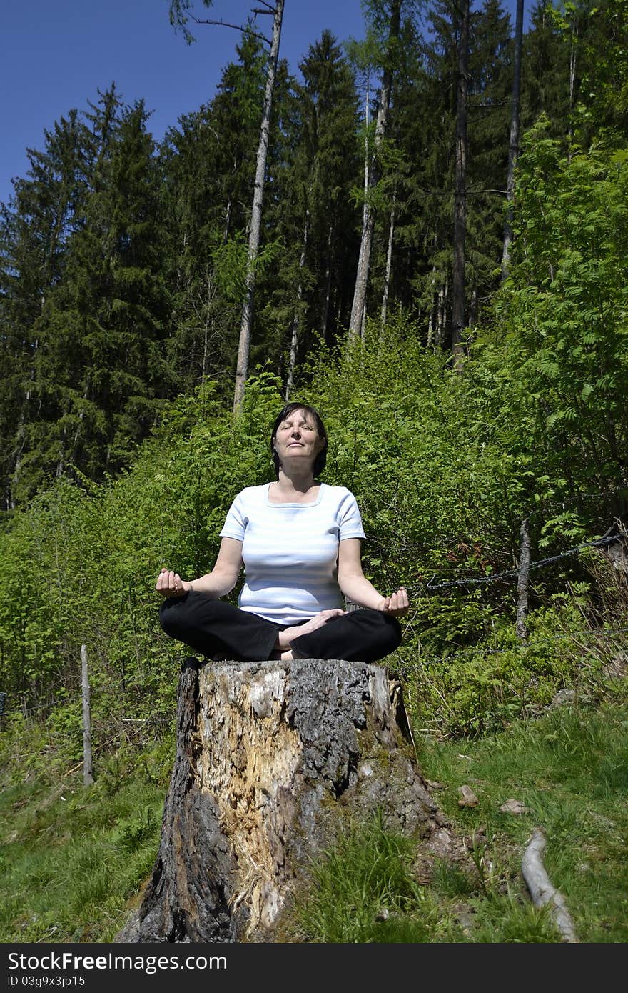 Senior woman practicing yoga in the forest. Senior woman practicing yoga in the forest.