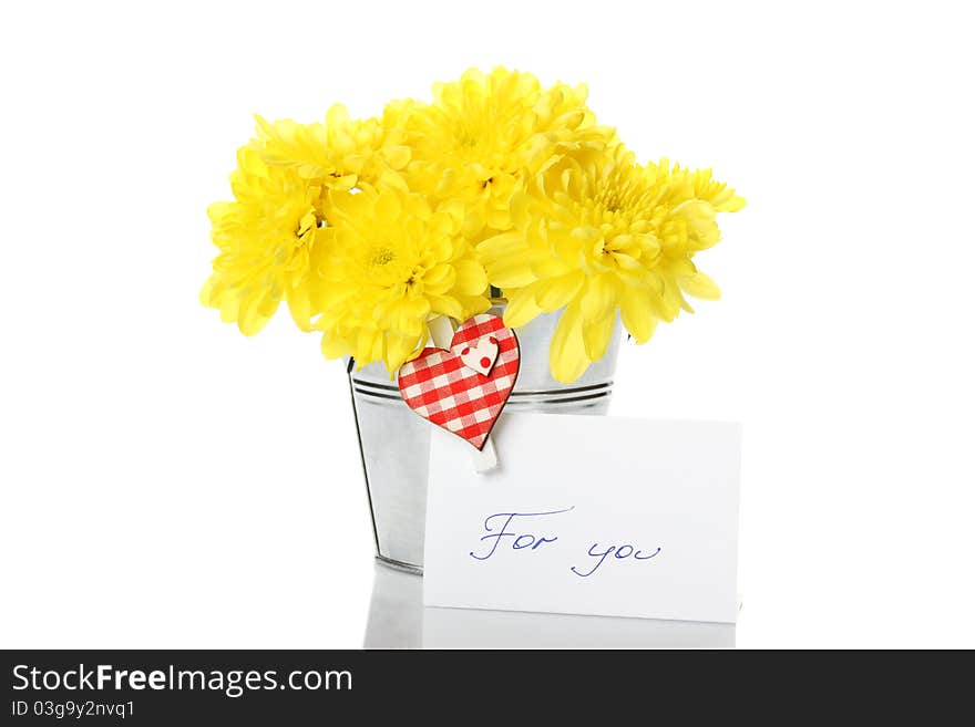 Yellow chrysanthemums in a bucket with chrysanthemums next card with the text for you and a pin with a red heart. Isolated. Yellow chrysanthemums in a bucket with chrysanthemums next card with the text for you and a pin with a red heart. Isolated