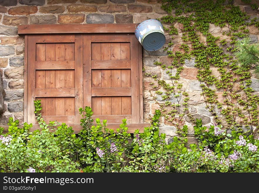 Closed wood window on aged brick wall