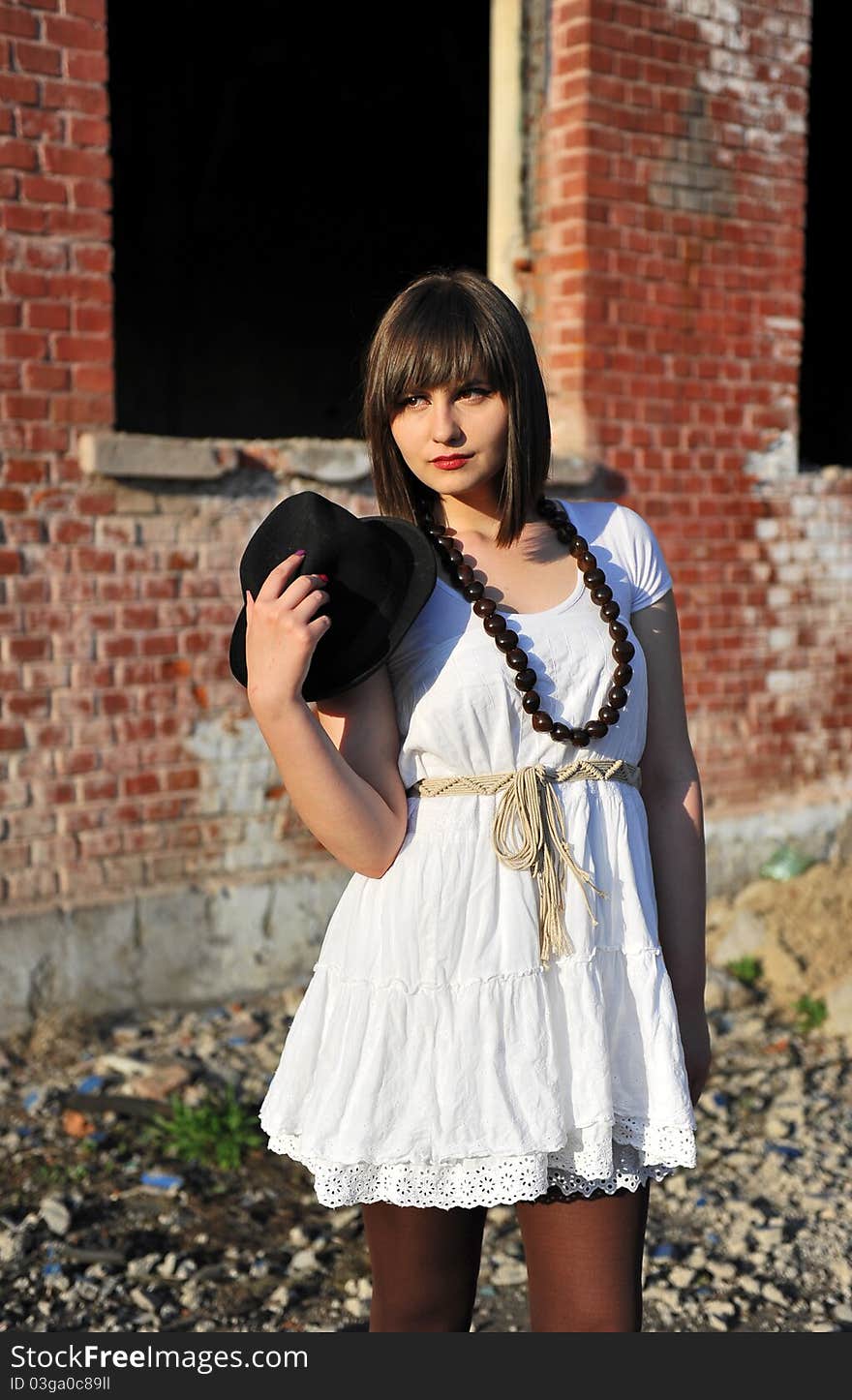 Portrait with beautiful young woman with hat in her hand, stylised vintage. Portrait with beautiful young woman with hat in her hand, stylised vintage