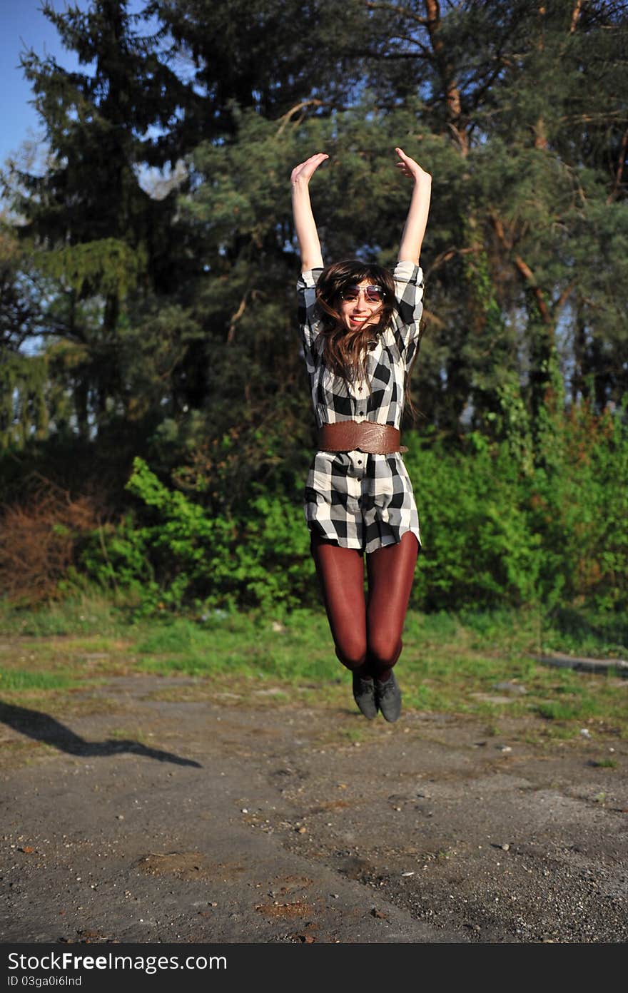 Portrait with happy young woman jumping