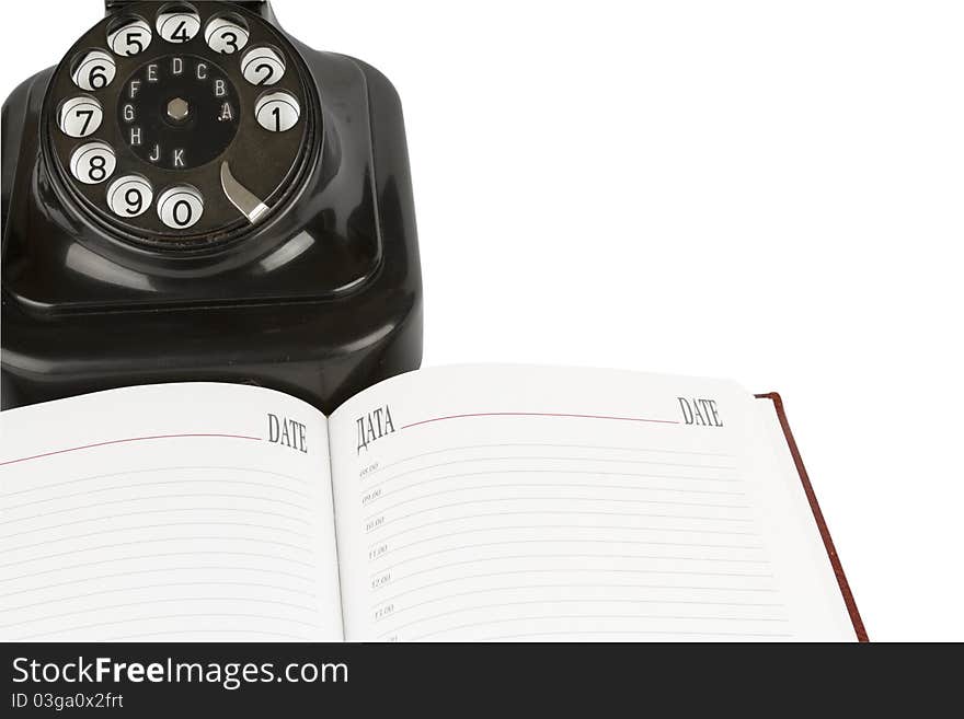 Black retro-styled telephone, organizer of open blank page isolated on white background. Black retro-styled telephone, organizer of open blank page isolated on white background