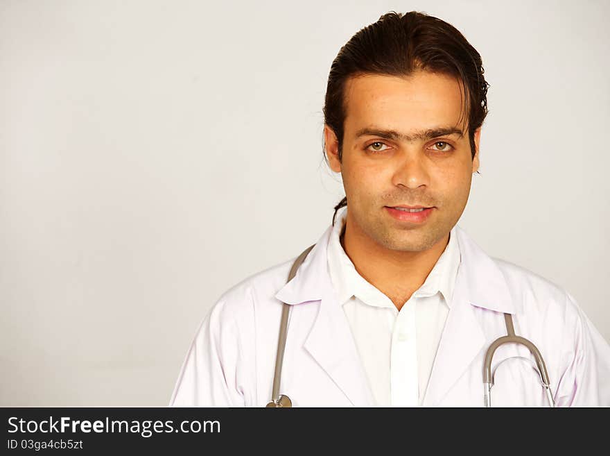 A portrait of a medical doctor posing against white background