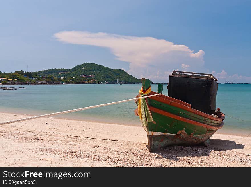 Wooden boat on the beach with blue sky