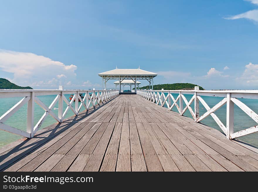 White bridge in to the sea with blue sky