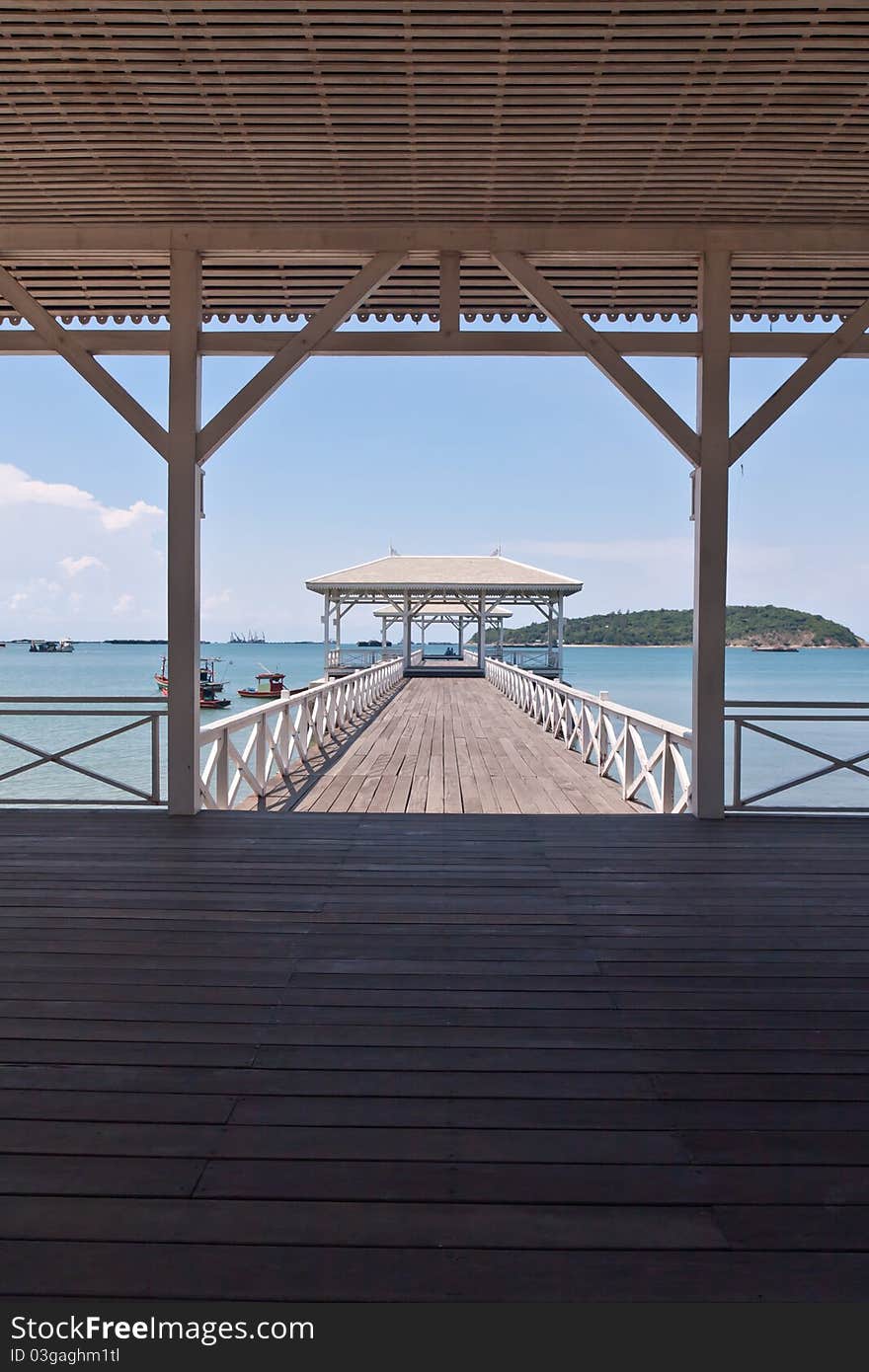 White bridge in to the sea with beautiful blue sky in vertical from the inside. White bridge in to the sea with beautiful blue sky in vertical from the inside