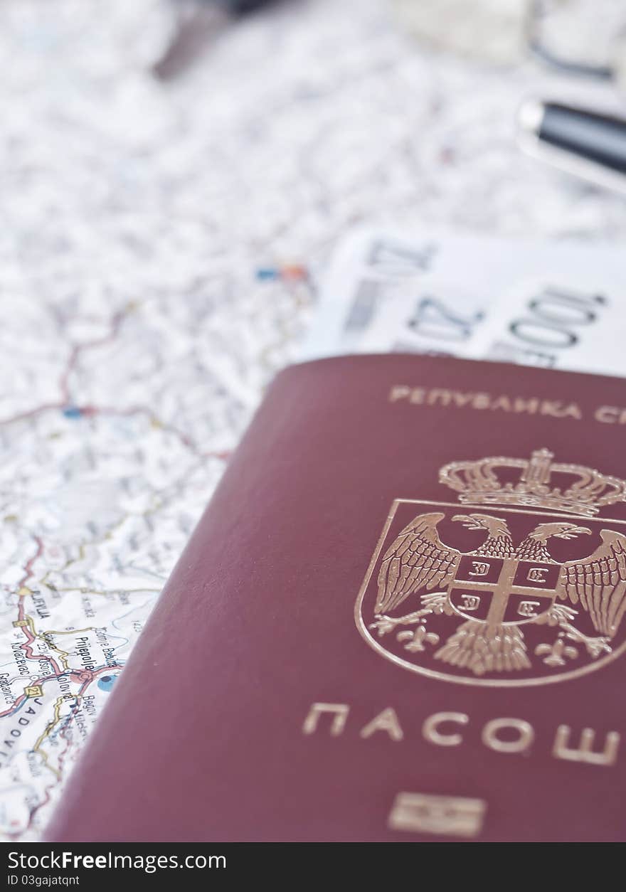 A closeup picture of an serbian passport. Map background , vertical composition. A closeup picture of an serbian passport. Map background , vertical composition