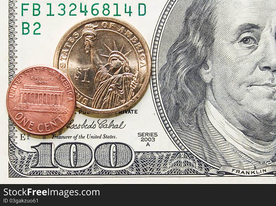 One Cent And Dollar Coins On One Hundred Bill