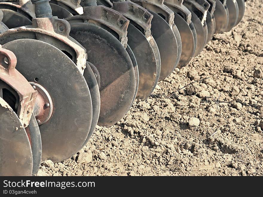 Harrow. Agricultural machinery. Cultivation of land. Metal discs to break ground. Sowing time. Harrow. Agricultural machinery. Cultivation of land. Metal discs to break ground. Sowing time.