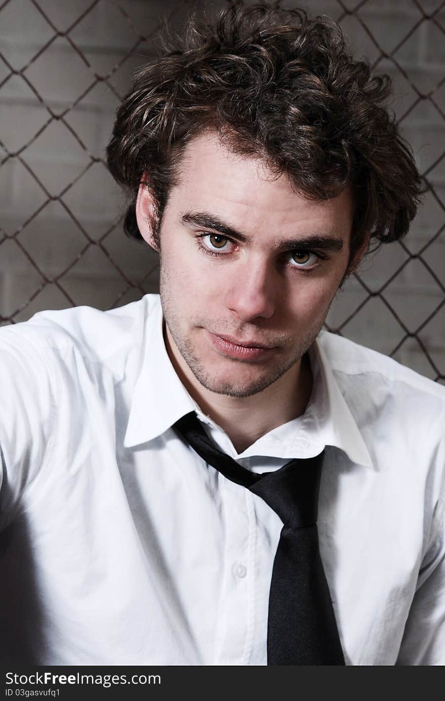 Portrait of an attractive business man, with a serious thoughful look on his face. against an industrial background. Portrait of an attractive business man, with a serious thoughful look on his face. against an industrial background