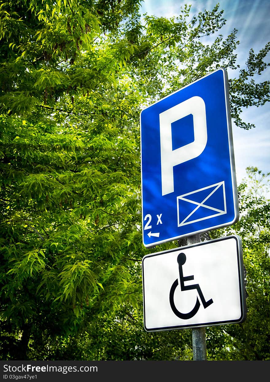 Parking place sign for disabled in sun rays