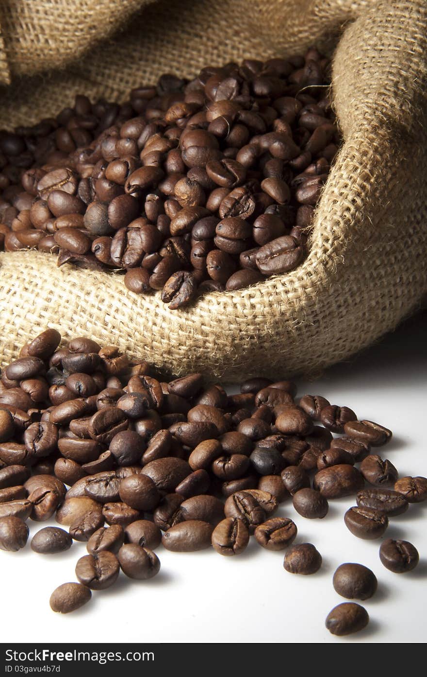 Coffee Beans with coffee bag on a white surface