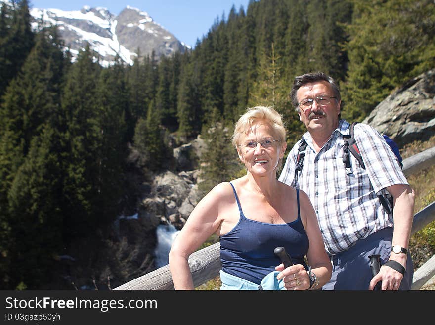 Retired Couple Hiking In The Alps