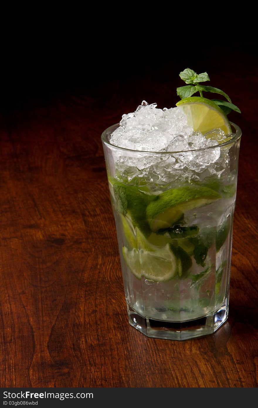 Mojito Cocktail on a wooden table with ice