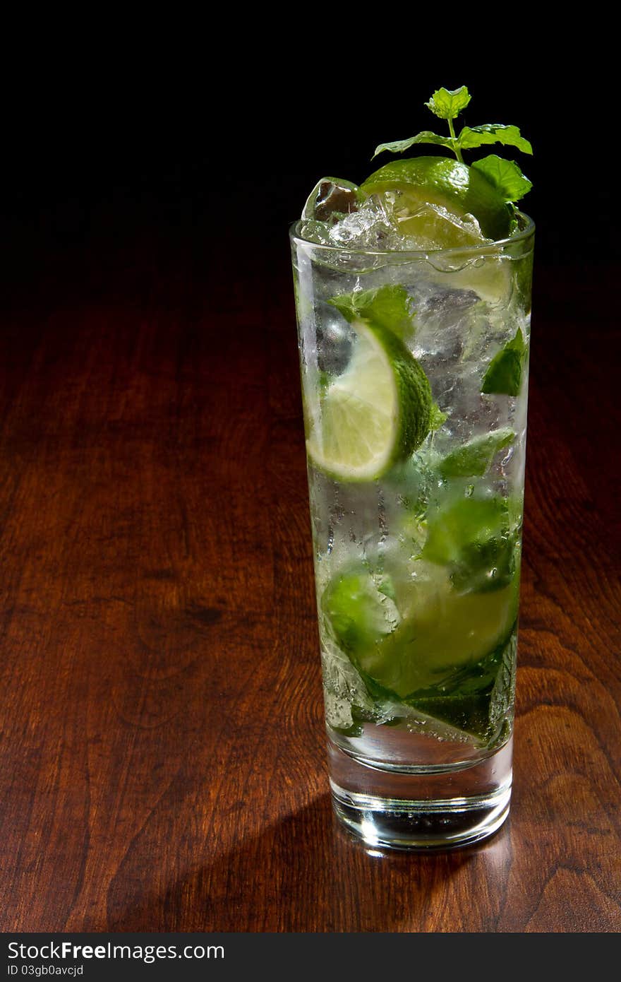 Mojito Cocktail on a wooden table with ice