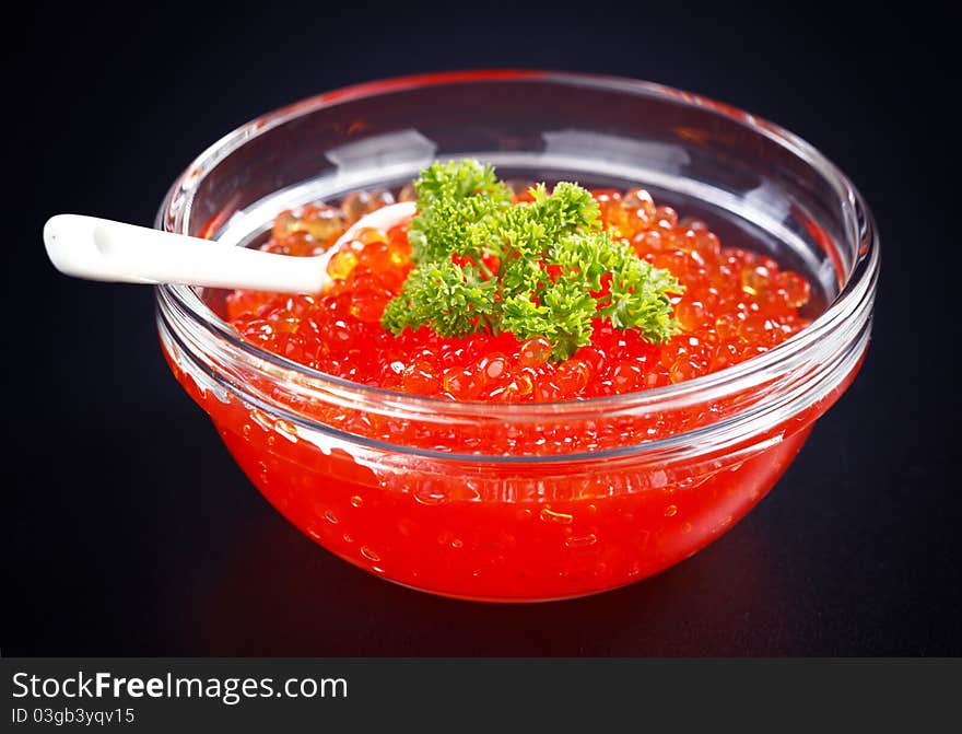 Red caviar on the black background