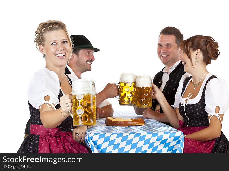 Bavarian men and women toast with Oktoberfest beer stein. Isolated on white background.