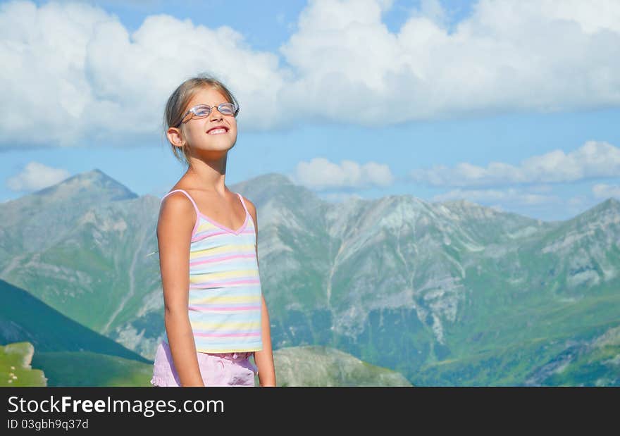 Girl hiker standing on a rock and looking at the mountains. Girl hiker standing on a rock and looking at the mountains