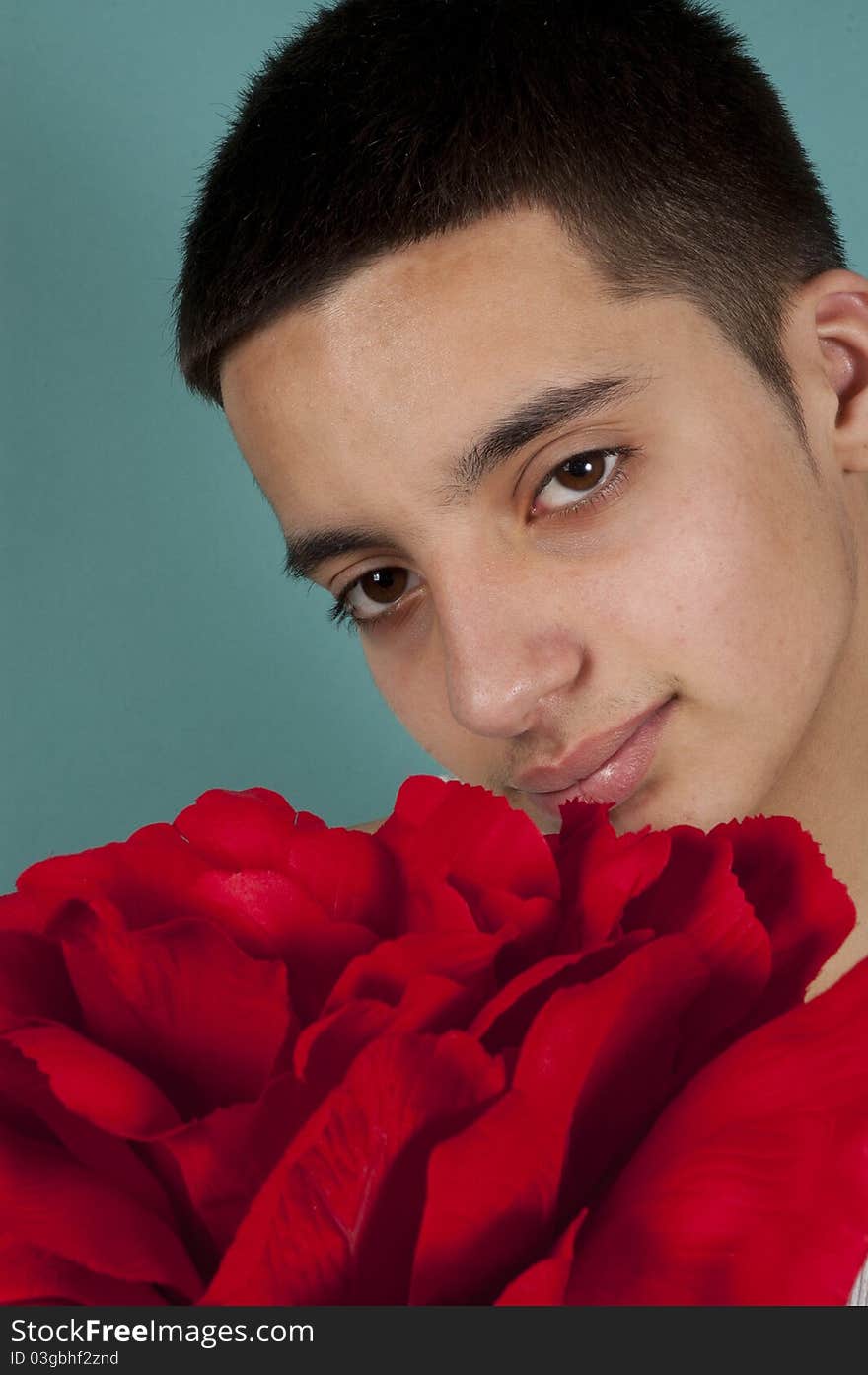 Teenage Pakistani Boy Holding A Red Rose