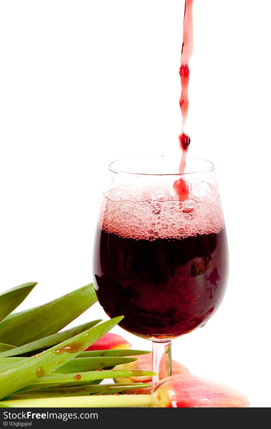 Red wine pouring into wine glass