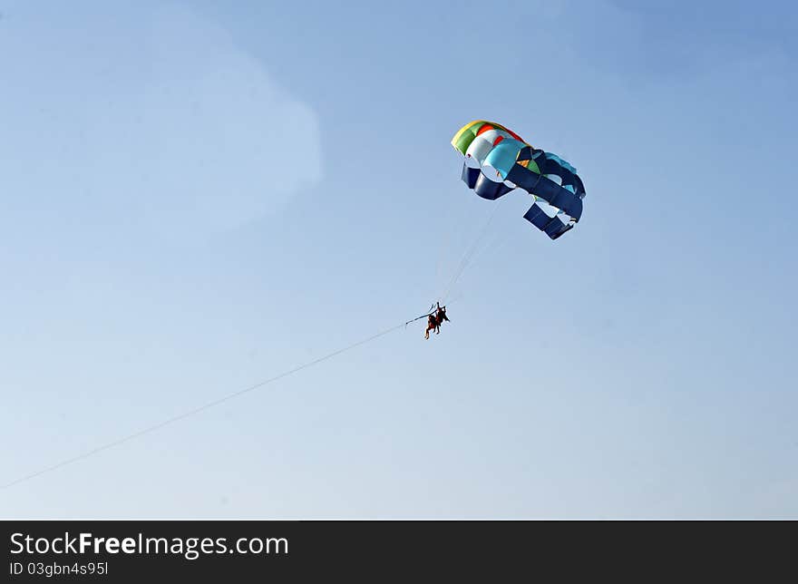 Man woman paragliding blue sky India