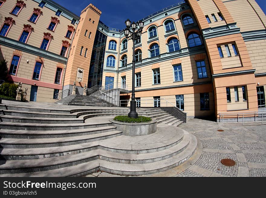 Facade of the building in pastel colors and a stylish lantern