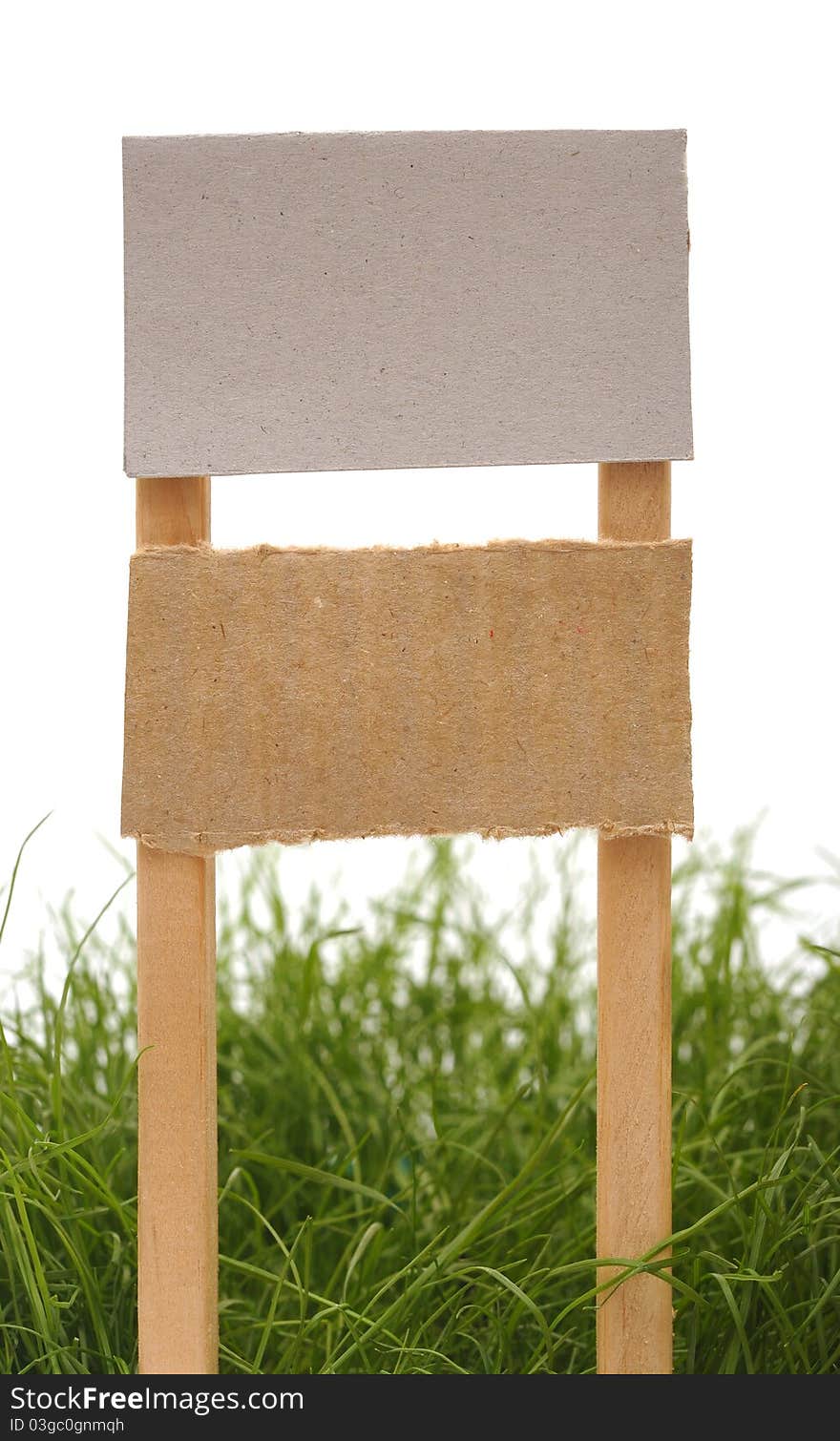 Cardboard sign with grass isolated on a white background