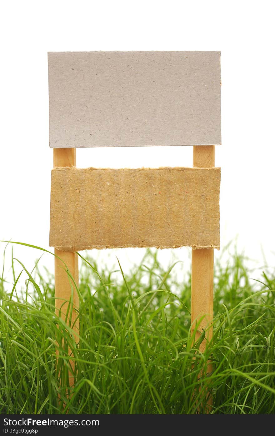 Cardboard sign with grass isolated on a white background