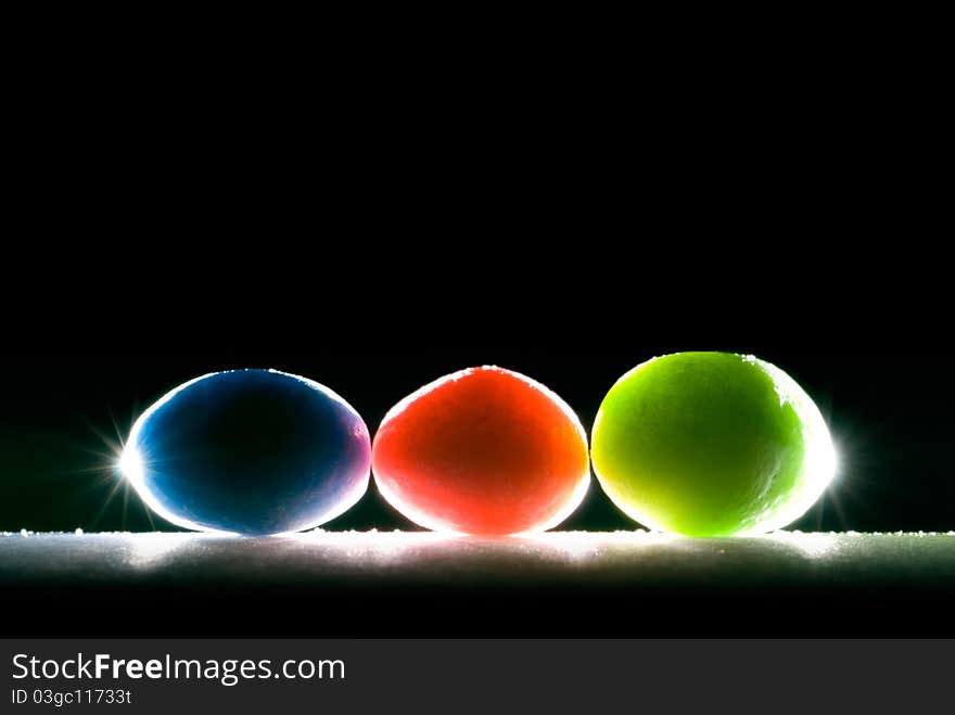 Beautiful colored candies (oval) on black background. Beautiful colored candies (oval) on black background.