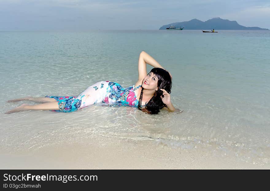 Young sensuality beautiful teen lays on clear crystal beach during holiday. Young sensuality beautiful teen lays on clear crystal beach during holiday