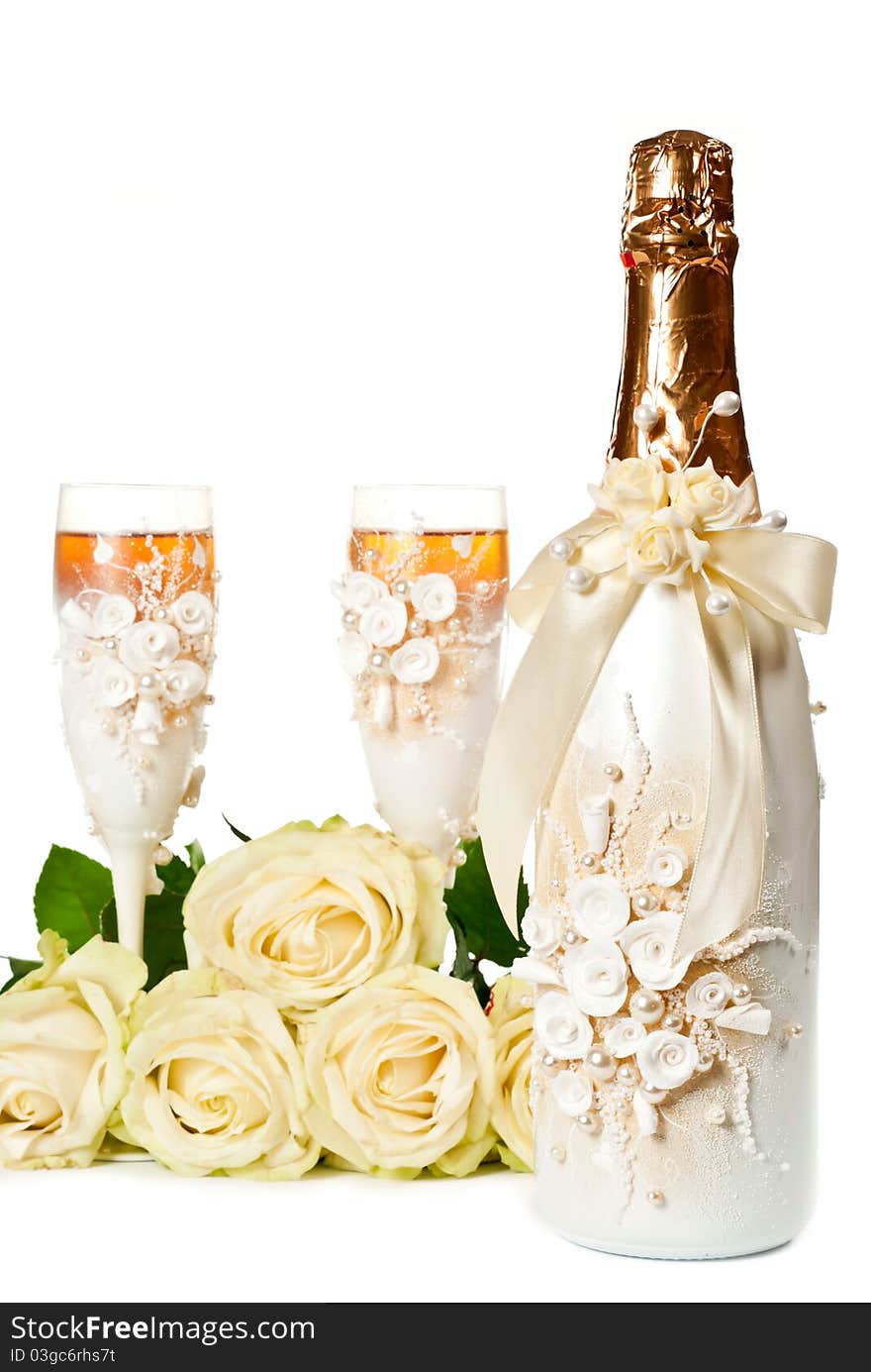 Two glasses of celebratory champagne with white roses. Two glasses of celebratory champagne with white roses